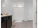 Bright bathroom featuring neutral tile flooring, granite counters, and a shower with a white curtain at 3255 Hilltop Cir, Bradenton, FL 34211