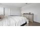 Bright bedroom featuring a comfortable bed and a classic wooden dresser with drawers at 3255 Hilltop Cir, Bradenton, FL 34211