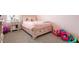 Cozy bedroom featuring a charming bed, complemented by stylish side table and toys at 3255 Hilltop Cir, Bradenton, FL 34211