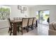 Elegant dining room with seating for six and sliding glass doors to the backyard at 3255 Hilltop Cir, Bradenton, FL 34211