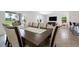 Open-concept dining area with a long table and chairs adjacent to a living space at 3255 Hilltop Cir, Bradenton, FL 34211
