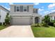 Charming two-story home with stone accents, a two-car garage, and landscaped front yard at 3255 Hilltop Cir, Bradenton, FL 34211
