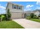 Inviting two-story home with a two-car garage and beautifully landscaped front yard at 3255 Hilltop Cir, Bradenton, FL 34211