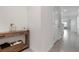Bright hallway featuring a wooden console table with stylish decor and neutral wall paint at 3255 Hilltop Cir, Bradenton, FL 34211
