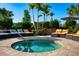 Relaxing hot tub with comfortable lounge chairs and lush landscaping offers a private outdoor oasis at 3255 Hilltop Cir, Bradenton, FL 34211