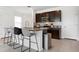Kitchen island with seating and granite countertops, plus dark wood cabinets at 3255 Hilltop Cir, Bradenton, FL 34211