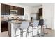 Kitchen island with seating and granite countertops, plus dark wood cabinets at 3255 Hilltop Cir, Bradenton, FL 34211