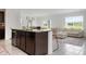 Contemporary kitchen with granite island open to a living area with a plush sofa at 3255 Hilltop Cir, Bradenton, FL 34211