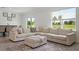 Bright living room featuring a comfortable sectional sofa and a view of the landscaped yard at 3255 Hilltop Cir, Bradenton, FL 34211