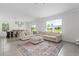 Spacious living room with large sectional sofa and patterned rug near the dining area at 3255 Hilltop Cir, Bradenton, FL 34211