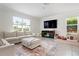 Cozy living room featuring a comfortable sectional sofa, flat-screen TV, and decorative rug at 3255 Hilltop Cir, Bradenton, FL 34211
