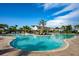 Outdoor pool with clear blue water surrounded by lounge chairs, palm trees and cabanas on a sunny day at 3255 Hilltop Cir, Bradenton, FL 34211