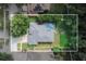 Aerial view of a well-maintained home with a screened-in pool, surrounded by lush greenery at 4428 Winding River Drive, Valrico, FL 33596