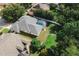 Aerial view of a home with a screened-in pool and a well-maintained backyard at 4428 Winding River Drive, Valrico, FL 33596