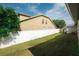 Spacious backyard with lush green grass and a well-maintained white fence ensuring privacy at 4428 Winding River Drive, Valrico, FL 33596
