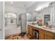 Bright bathroom featuring dual sinks, soaking tub, and walk in shower at 4428 Winding River Drive, Valrico, FL 33596