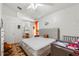 Bright bedroom featuring a large bed, walk in bathroom, ceiling fan, and decorative floors at 4428 Winding River Drive, Valrico, FL 33596
