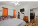 Bright bedroom featuring a large bed, ceiling fan, and decorative floors with a view to the living room at 4428 Winding River Drive, Valrico, FL 33596