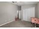 Neutral-colored bedroom with a double closet provides ample space and plenty of storage at 4428 Winding River Drive, Valrico, FL 33596
