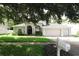 Charming single Gathering home with a well-maintained lawn, mature landscaping, and a three car garage at 4428 Winding River Drive, Valrico, FL 33596