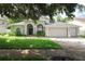 Charming single Gathering home with a well-maintained lawn, mature landscaping, and a three car garage at 4428 Winding River Drive, Valrico, FL 33596
