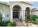 Home's inviting front entrance with manicured garden and decorative accents at 4428 Winding River Drive, Valrico, FL 33596
