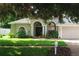A single-story home with well-maintained landscaping and a two-car garage at 4428 Winding River Drive, Valrico, FL 33596
