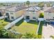 Aerial view of a fenced backyard with healthy green grass and solar panels adorning the roof at 4502 Banyan Tree Pl, Riverview, FL 33578