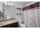 Granite countertop bathroom with decorative shelves and a shower with decorative curtain at 4502 Banyan Tree Pl, Riverview, FL 33578
