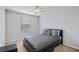 Bedroom with a ceiling fan and a large window with a black and gray patterned comforter set at 4502 Banyan Tree Pl, Riverview, FL 33578