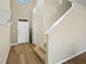 Inviting foyer with wood-look floors, a coat rack and a staircase leading to the upper level at 4502 Banyan Tree Pl, Riverview, FL 33578