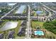 Expansive aerial view of a well-planned community featuring interconnected lakes, pools, and beautiful landscaping at 1718 Trailwater St, Ruskin, FL 33570