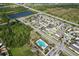 Aerial view featuring lush greenery, serene ponds, and a community pool for relaxation and recreation at 1718 Trailwater St, Ruskin, FL 33570