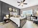 Stylish bedroom with a panel accent wall, neutral tones, and modern furnishings at 1718 Trailwater St, Ruskin, FL 33570