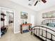 Comfortable bedroom featuring a metal bed frame, tiled flooring, and modern decor at 1718 Trailwater St, Ruskin, FL 33570