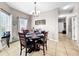 Cozy dining area features a round table, chandelier, and access to the hallway at 1718 Trailwater St, Ruskin, FL 33570