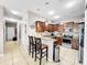 Efficient kitchen with granite countertops, stainless steel appliances, and breakfast bar seating at 1718 Trailwater St, Ruskin, FL 33570