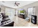 Cozy living room with tiled floors, plush furniture, and plenty of natural light at 1718 Trailwater St, Ruskin, FL 33570