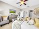 Bright main bedroom with modern decor, ceiling fan, and closet access for storage at 1718 Trailwater St, Ruskin, FL 33570
