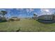 A peaceful, serene neighborhood street with lush green lawns and sidewalks at 1718 Trailwater St, Ruskin, FL 33570