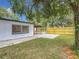 This backyard features a new wooden fence, concrete patio, and a spacious carport at 4202 W Bay Vista Ave, Tampa, FL 33611