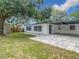 Spacious backyard with a covered patio and mature trees providing plenty of shade at 4202 W Bay Vista Ave, Tampa, FL 33611