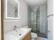 Modern bathroom with new vanity, sleek sliding glass shower, tile and mirrored medicine cabinet at 4202 W Bay Vista Ave, Tampa, FL 33611