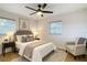 Comfortable bedroom featuring a ceiling fan, natural light, and a cozy armchair for relaxation at 4202 W Bay Vista Ave, Tampa, FL 33611