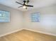 Light and airy bedroom with two windows and a ceiling fan at 4202 W Bay Vista Ave, Tampa, FL 33611