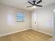 Bedroom featuring a ceiling fan, a window with blinds, and access to an en-suite bathroom at 4202 W Bay Vista Ave, Tampa, FL 33611