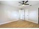 A naturally lit bedroom with new ceiling fan, hardwood floors, closet and a window at 4202 W Bay Vista Ave, Tampa, FL 33611
