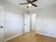 Bedroom with fan, new flooring, and an en-suite bathroom with a step-in shower at 4202 W Bay Vista Ave, Tampa, FL 33611