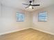 A well-lit bedroom featuring new floors and multiple windows at 4202 W Bay Vista Ave, Tampa, FL 33611
