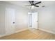Bright bedroom with wood-look floors, a ceiling fan, and a closet at 4202 W Bay Vista Ave, Tampa, FL 33611
